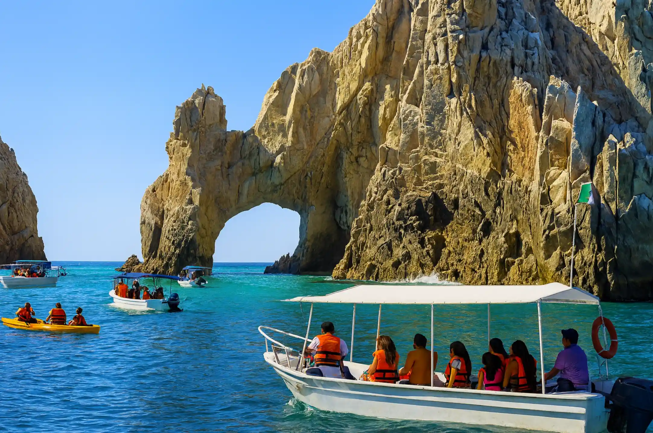 Boat crowds near the Arch during sunset in Cabo San Lucas