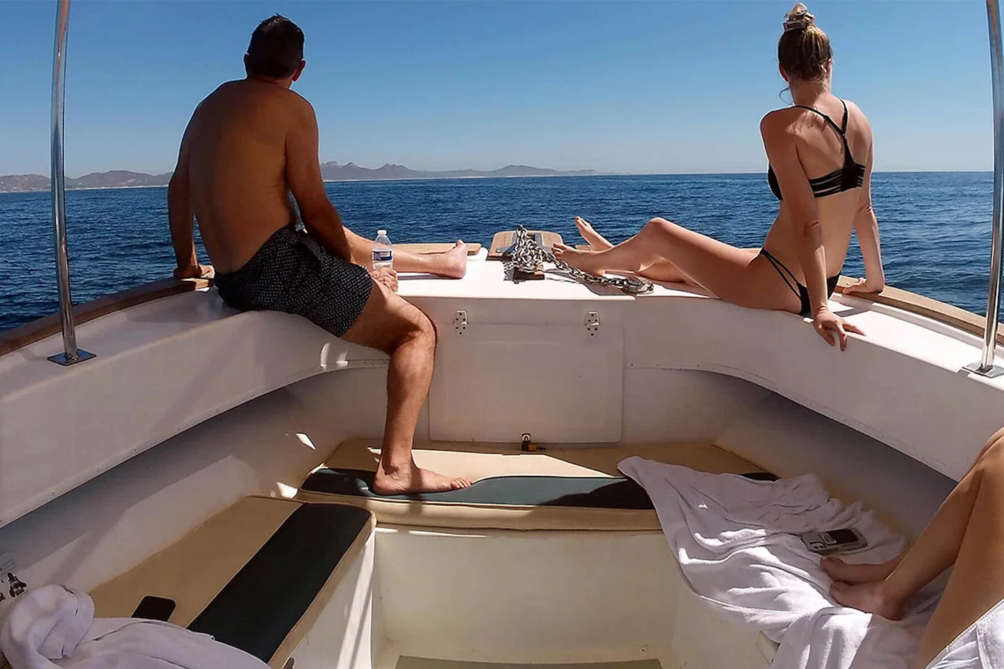 Guests relaxing on the spacious bow of the Super Salty tour boat while enjoying beautiful ocean views along the San José del Cabo coastline.