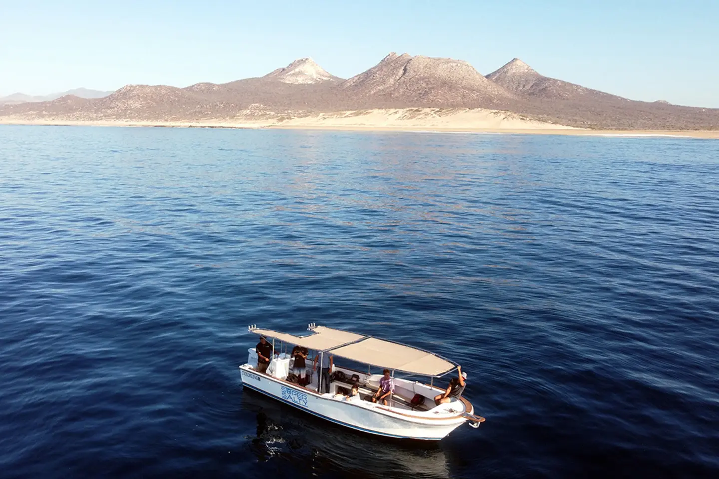 Aerial view of the Super Salty tour boat cruising along the beautiful Sea of Cortez coastline near San José del Cabo, Baja California Sur.