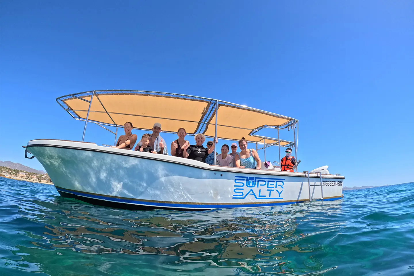 Guests enjoying a small-group excursion aboard the Super Salty 27ft tour boat, with shaded seating on the beautiful Sea of Cortez near San José del Cabo.